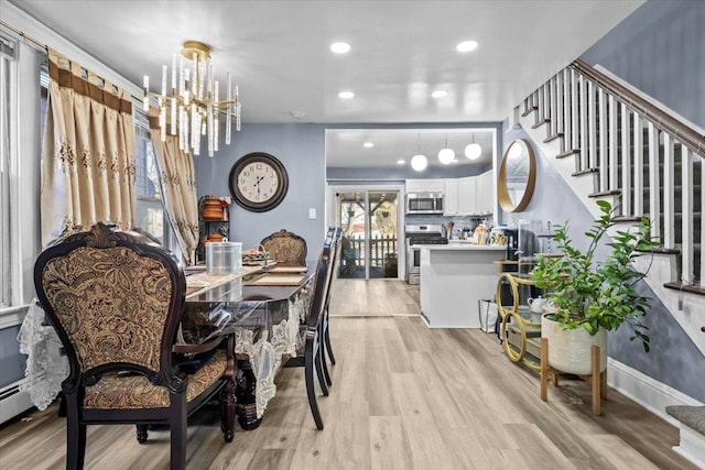 dining space featuring a chandelier and light hardwood / wood-style flooring