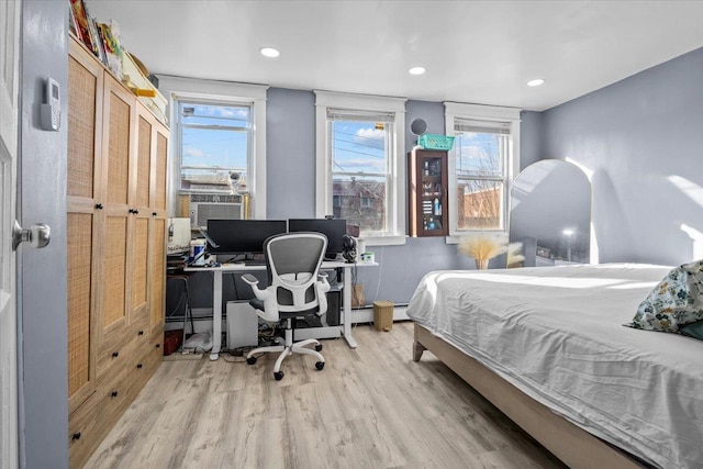 bedroom featuring light hardwood / wood-style flooring and cooling unit