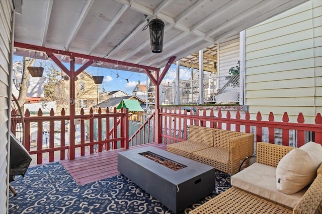 wooden deck with an outdoor living space with a fire pit