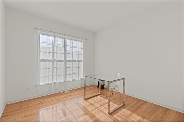 unfurnished room with light hardwood / wood-style floors