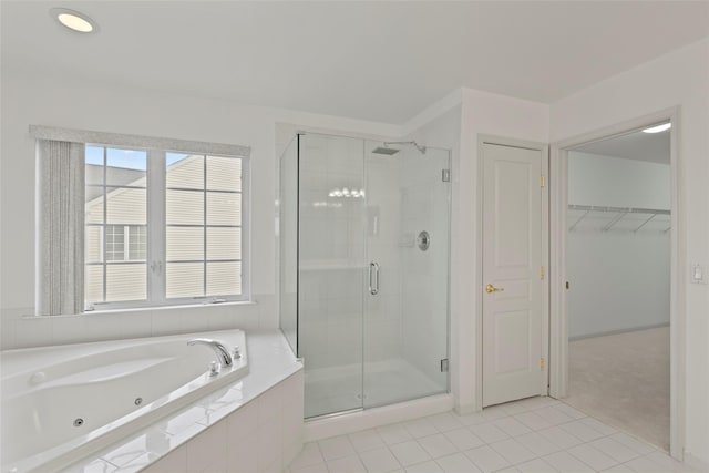 bathroom with separate shower and tub and tile patterned floors