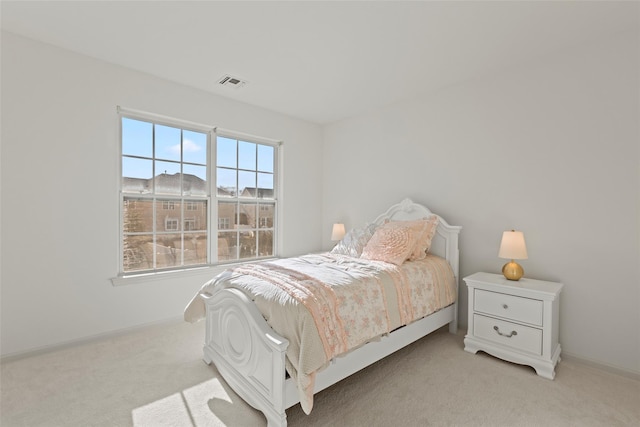 bedroom featuring light colored carpet