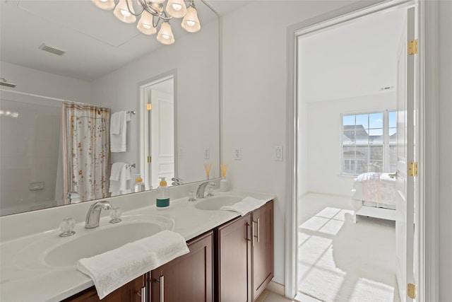 bathroom with vanity and a chandelier