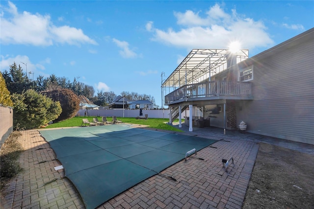 view of swimming pool with a yard, a patio, and a deck