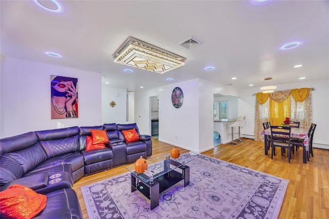 living room with baseboard heating and hardwood / wood-style flooring