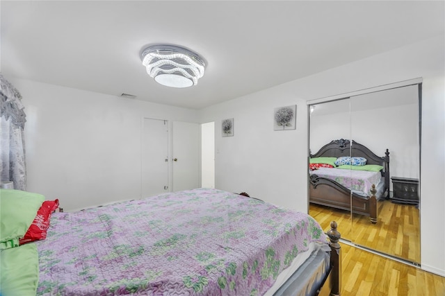 bedroom with hardwood / wood-style flooring and a closet