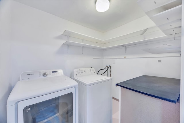 clothes washing area featuring independent washer and dryer