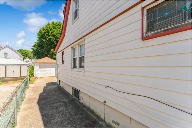 view of home's exterior with a garage and an outdoor structure