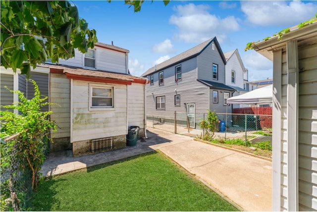 rear view of house featuring a yard