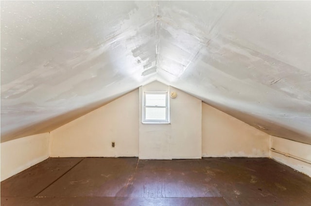 additional living space featuring lofted ceiling