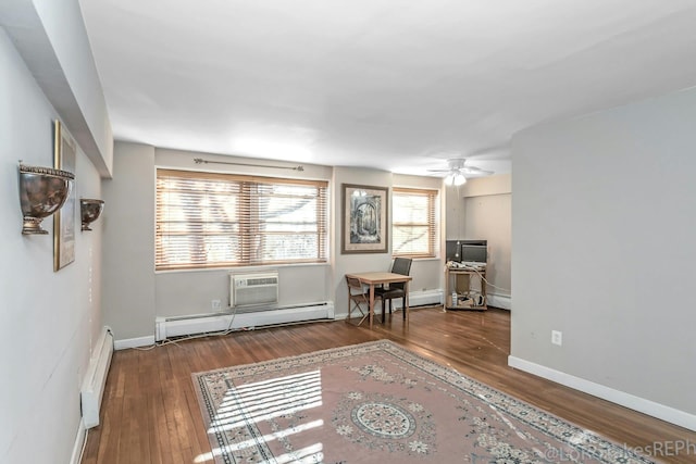 interior space featuring baseboard heating, a wall unit AC, ceiling fan, and hardwood / wood-style flooring