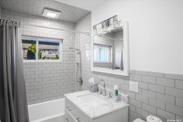 bathroom featuring vanity, shower / tub combo, and tile walls