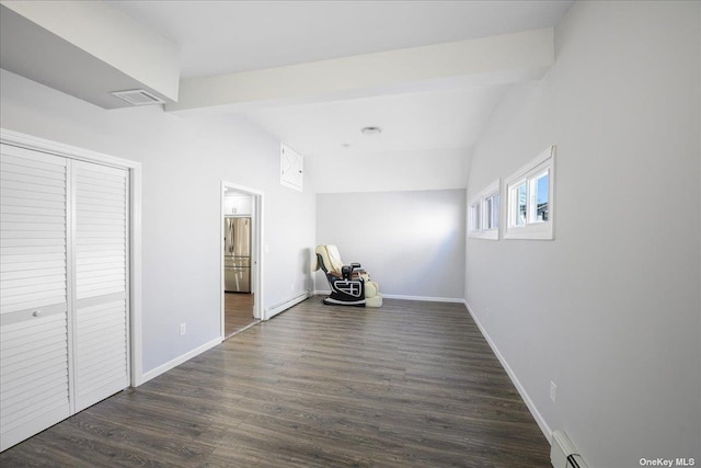 interior space with vaulted ceiling with beams, baseboard heating, and dark wood-type flooring