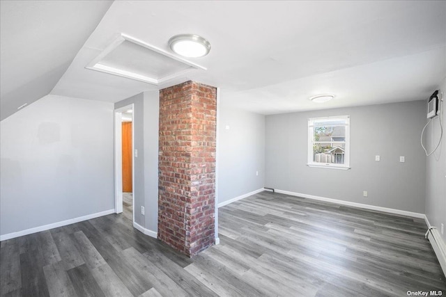 bonus room featuring dark hardwood / wood-style flooring and baseboard heating