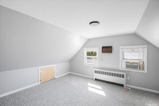 bonus room featuring carpet flooring, vaulted ceiling, radiator, and cooling unit