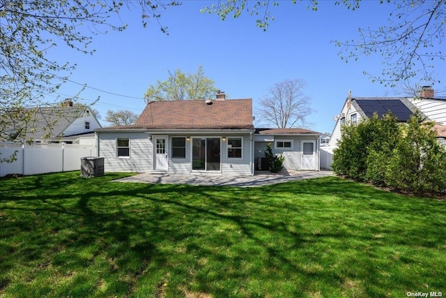 rear view of property featuring a lawn and a patio