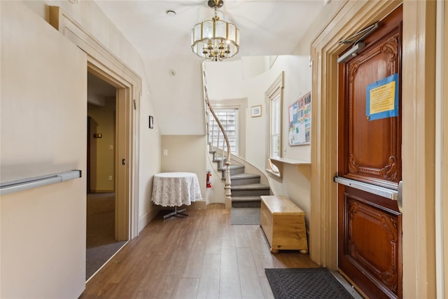 interior space with a notable chandelier and light wood-type flooring