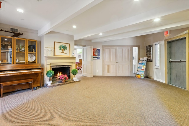 sitting room with carpet flooring and beam ceiling