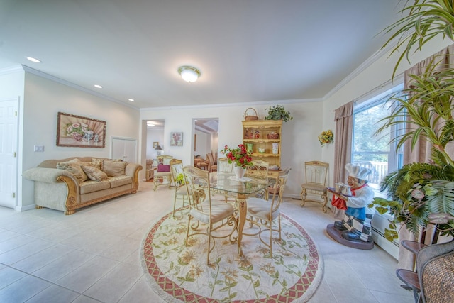 dining area with light tile patterned flooring and crown molding