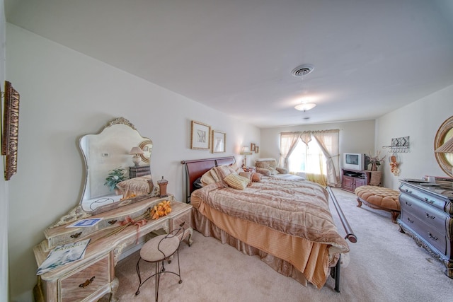 bedroom featuring light colored carpet