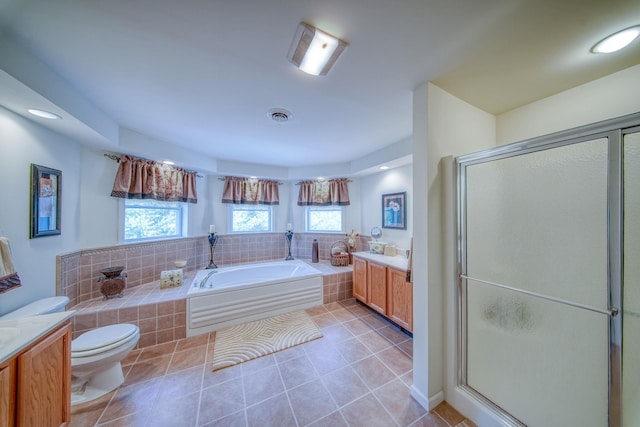 full bathroom with tile patterned flooring, vanity, toilet, and independent shower and bath