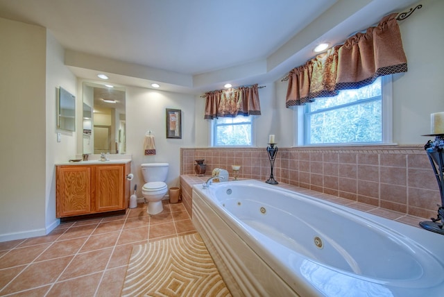 bathroom with tile patterned floors, vanity, toilet, and a bathing tub