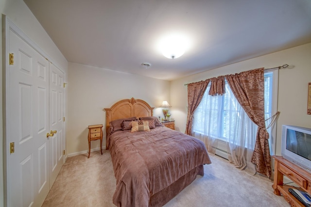 bedroom featuring a closet and light colored carpet