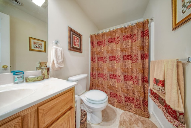 bathroom with tile patterned flooring, vanity, and toilet