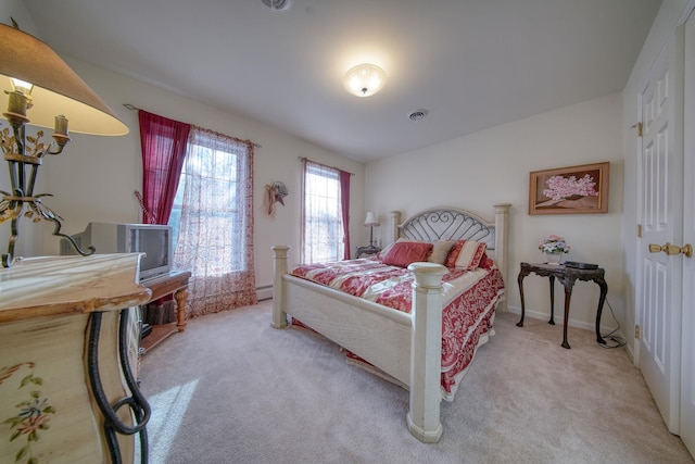 carpeted bedroom featuring a baseboard radiator