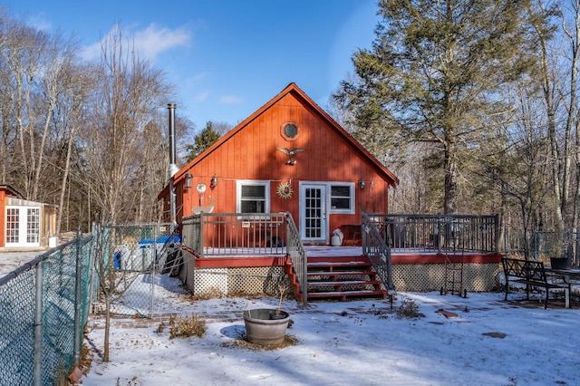 snow covered house with a deck