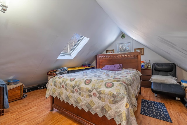 bedroom with wood-type flooring and vaulted ceiling