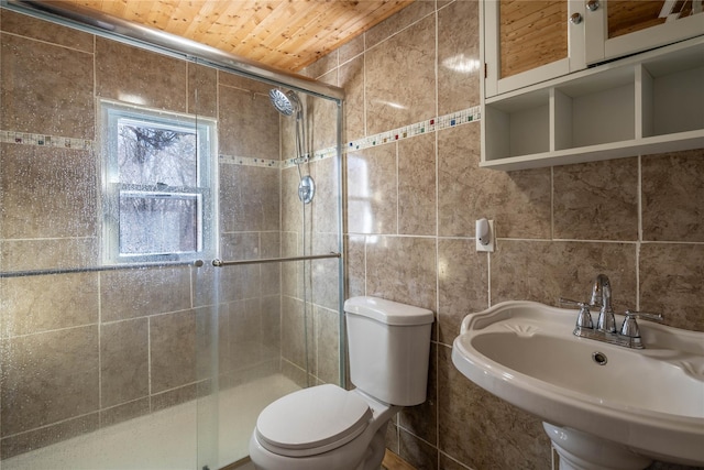 bathroom with toilet, tile walls, wooden ceiling, and sink