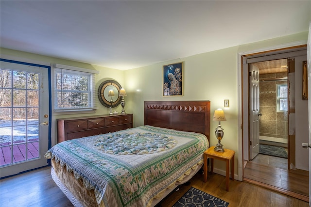 bedroom featuring access to outside, connected bathroom, and hardwood / wood-style flooring