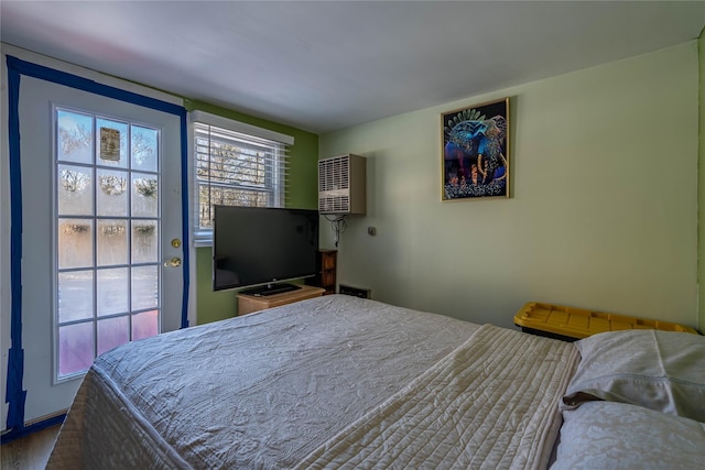 bedroom with an AC wall unit