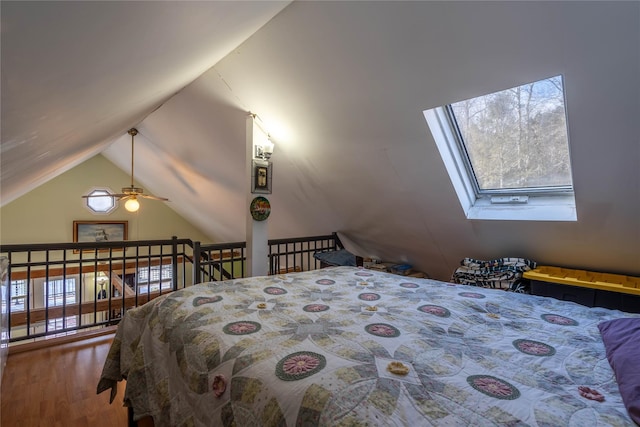 bedroom featuring wood-type flooring and vaulted ceiling with skylight