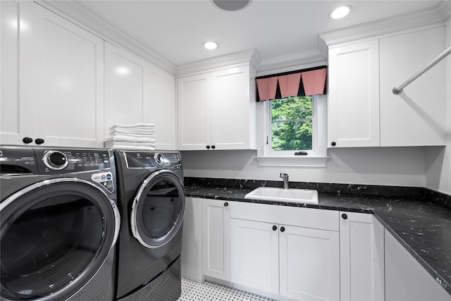 washroom featuring washer and dryer, crown molding, cabinets, and sink