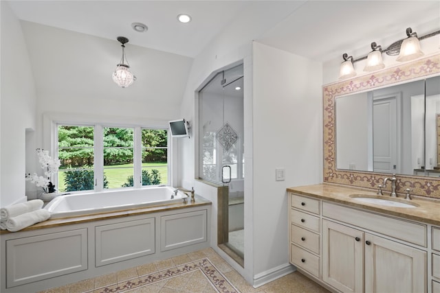 bathroom featuring vanity, lofted ceiling, backsplash, tile patterned floors, and shower with separate bathtub