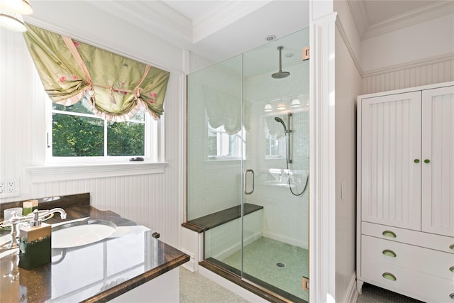 bathroom with vanity, an enclosed shower, and ornamental molding