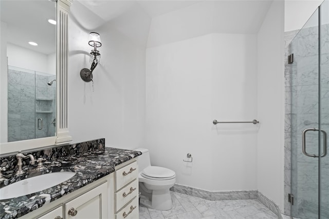 bathroom featuring vanity, toilet, and walk in shower