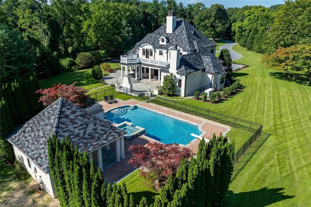 view of pool featuring a lawn and a patio