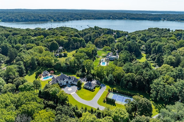 drone / aerial view with a water view and a wooded view