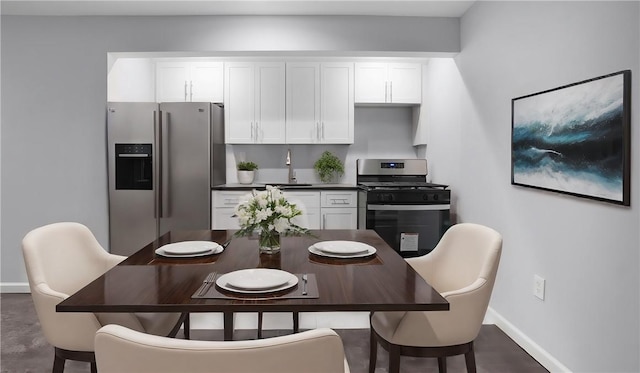 kitchen with white cabinets, appliances with stainless steel finishes, and sink