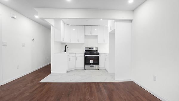 kitchen featuring stove, light hardwood / wood-style floors, white cabinetry, and sink