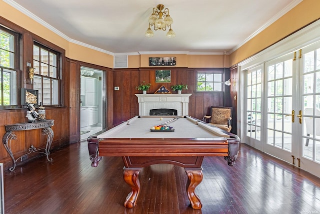 rec room with french doors, a brick fireplace, ornamental molding, dark wood-type flooring, and billiards