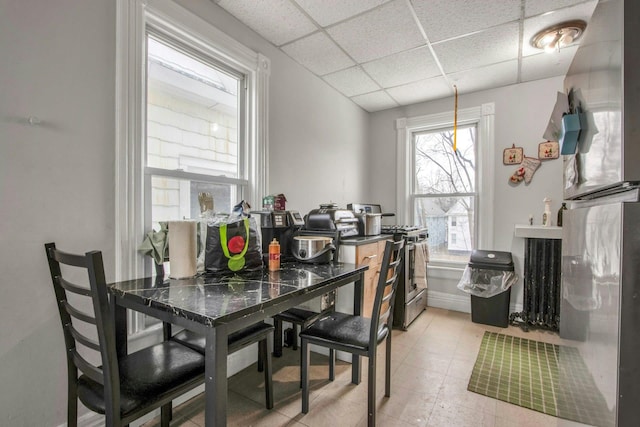 dining room with a drop ceiling