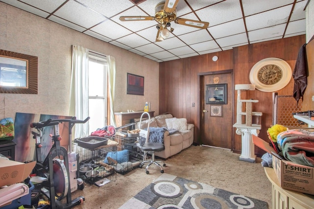 living room featuring carpet, a paneled ceiling, and ceiling fan