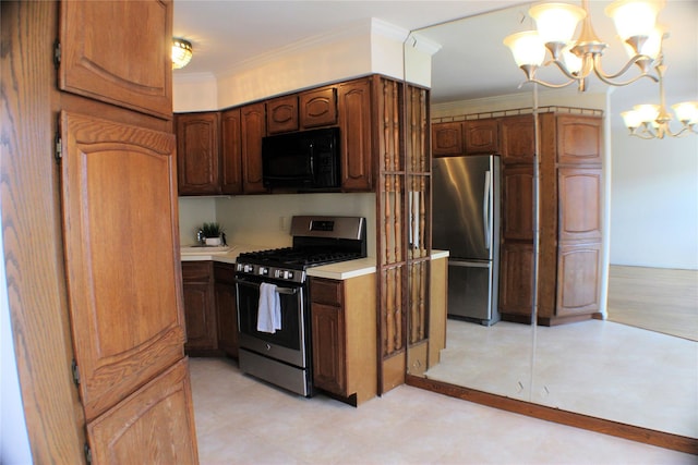 kitchen with crown molding, hanging light fixtures, stainless steel appliances, and a notable chandelier