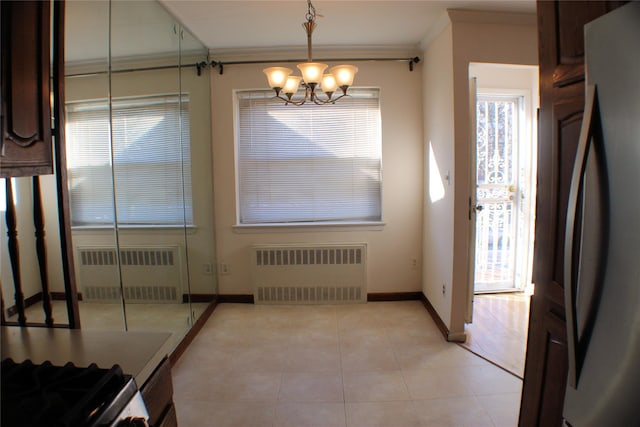 unfurnished dining area featuring radiator, crown molding, light tile patterned flooring, and an inviting chandelier