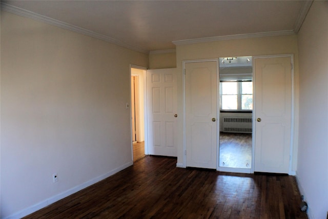 unfurnished bedroom with radiator heating unit, dark hardwood / wood-style flooring, a closet, and ornamental molding