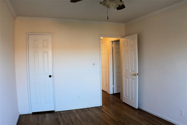 unfurnished bedroom with ceiling fan, crown molding, and dark wood-type flooring